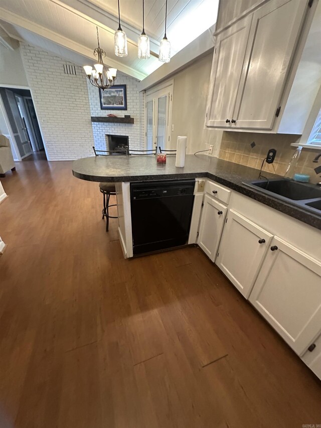 213 S Adcock, Dumas, AR 71639 - kitchen with dishwasher, a brick fireplace, white cabinetry, dark wood-style flooring, and beamed ceiling