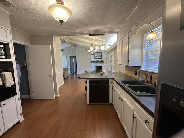 213 S Adcock, Dumas, AR 71639 - kitchen featuring black appliances, a sink, a chandelier, dark countertops, and a textured ceiling