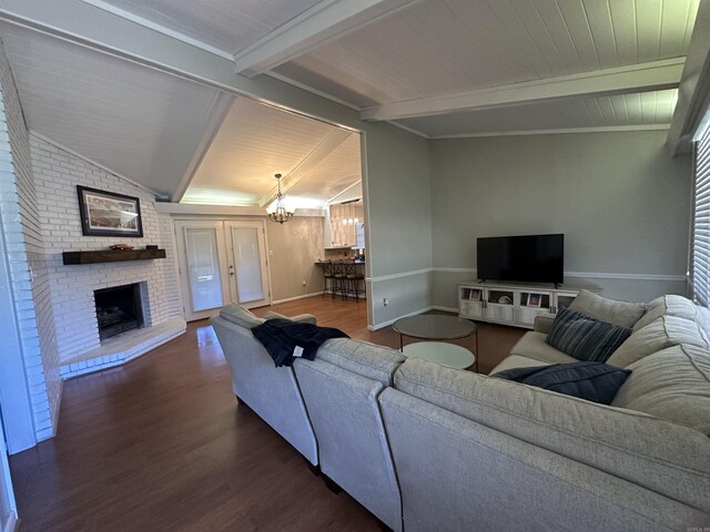 213 S Adcock, Dumas, AR 71639 - living room with dark wood-style flooring, a chandelier, a brick fireplace, baseboards, and wooden ceiling with exposed beams