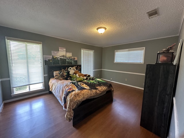 213 S Adcock, Dumas, AR 71639 - bedroom featuring a textured ceiling, wood finished floors, and baseboards