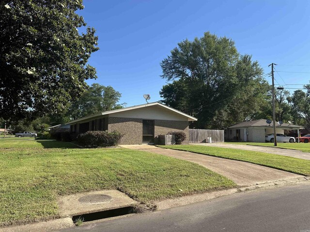 213 S Adcock, Dumas, AR 71639 - view of front of house with brick siding and driveway