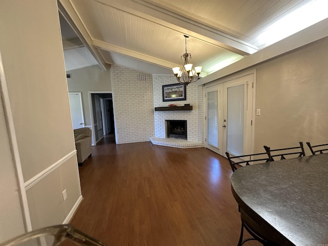 213 S Adcock, Dumas, AR 71639 - living area with a chandelier, dark wood-style flooring, and a fireplace