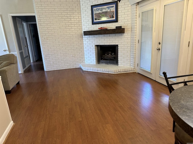 213 S Adcock, Dumas, AR 71639 - unfurnished living room with wood finished floors and a fireplace