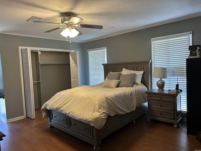 213 S Adcock, Dumas, AR 71639 - bedroom with dark wood finished floors, a closet, crown molding, a ceiling fan, and baseboards