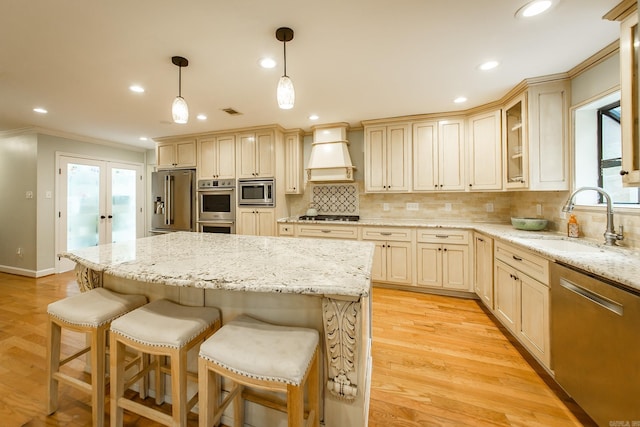 21221 Unicorn Ln, Roland, AR 72135 - kitchen featuring custom exhaust hood, stainless steel appliances, ornamental molding, a sink, and plenty of natural light