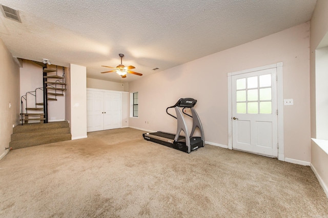 21221 Unicorn Ln, Roland, AR 72135 - workout area featuring carpet flooring, ceiling fan, baseboards, and a textured ceiling