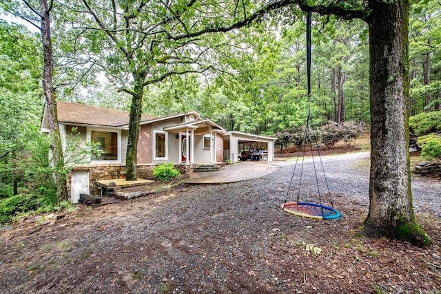 21221 Unicorn Ln, Roland, AR 72135 - view of front of property with concrete driveway, an attached carport, a porch, and stone siding
