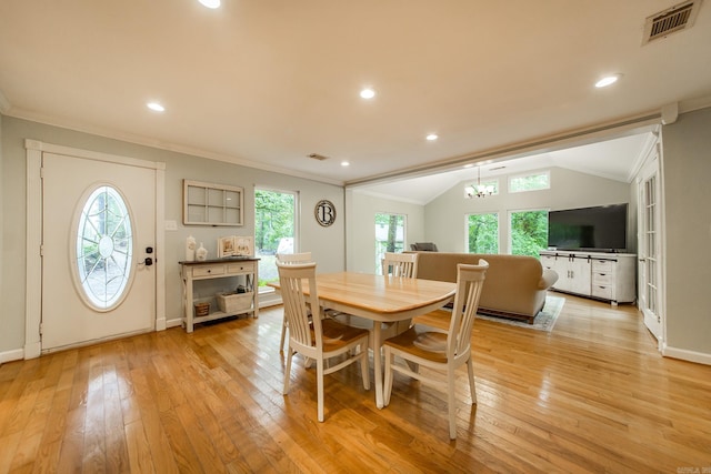 21221 Unicorn Ln, Roland, AR 72135 - dining space featuring crown molding, plenty of natural light, light wood-style flooring, a chandelier, and lofted ceiling