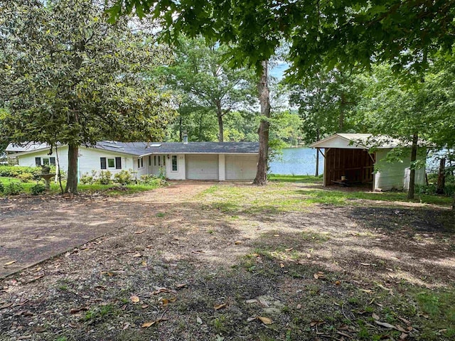 33 W Lakeshore Dr, Cherokee Village, AR 72529 - view of yard featuring driveway, a garage, and view of scattered trees