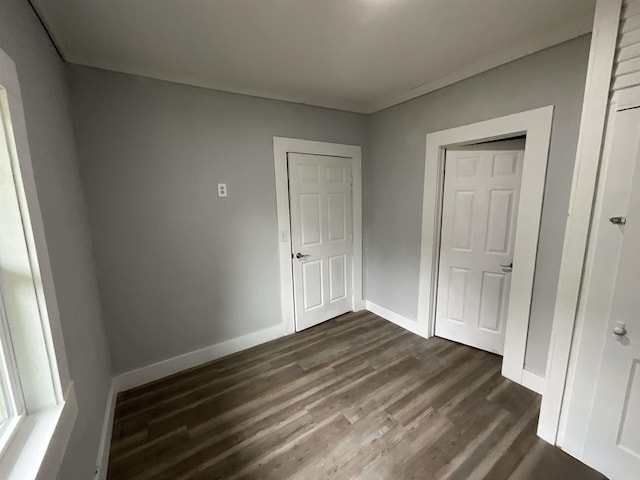 301 W Frazior, Linden, TX 75563 - unfurnished bedroom with dark wood-style floors and baseboards