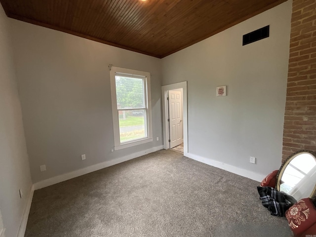 301 W Frazior, Linden, TX 75563 - unfurnished room featuring wood ceiling, carpet, and baseboards