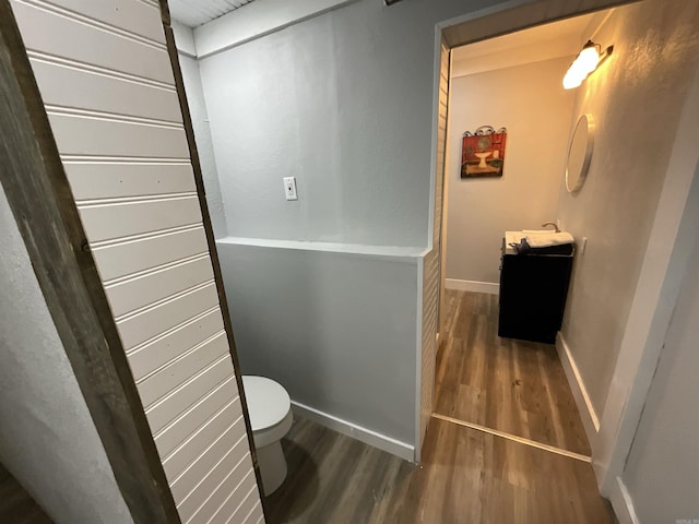 301 W Frazior, Linden, TX 75563 - bathroom with wood finished floors, toilet, vanity, and baseboards