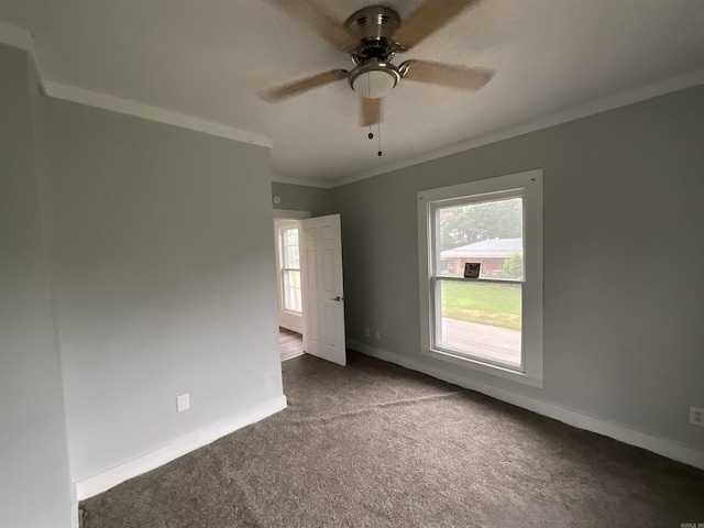 301 W Frazior, Linden, TX 75563 - empty room with crown molding, dark carpet, plenty of natural light, a ceiling fan, and baseboards