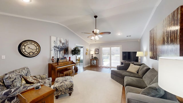living room with lofted ceiling, ceiling fan, wood finished floors, and baseboards