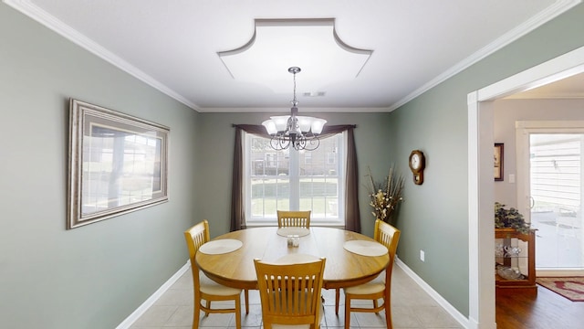 dining room featuring plenty of natural light, a chandelier, baseboards, and ornamental molding