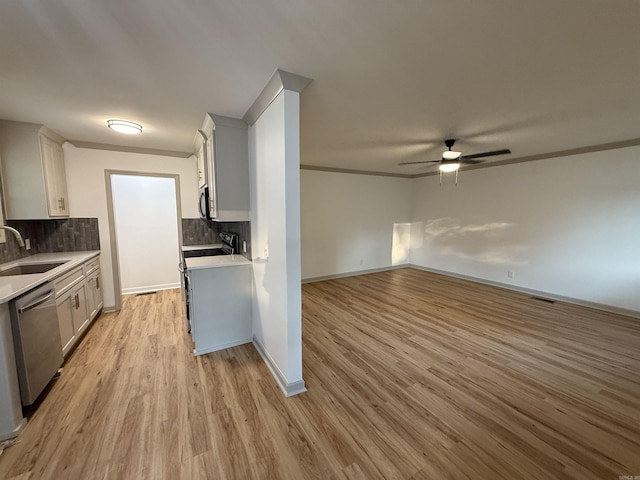 kitchen with dishwasher, a sink, a ceiling fan, light countertops, and tasteful backsplash