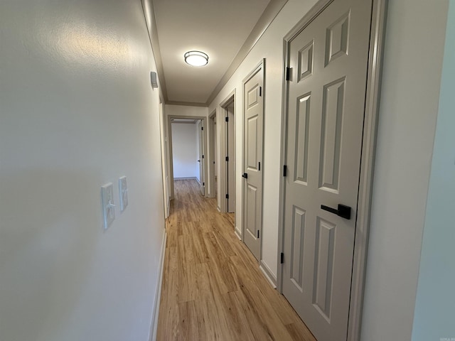 corridor featuring light wood-style flooring