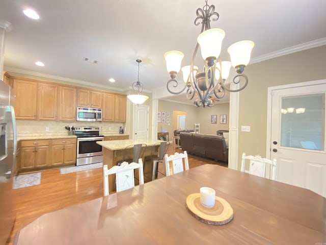 3008 Lilly Ln, Benton, AR 72019 - dining space featuring crown molding, light wood-style flooring, a chandelier, and recessed lighting