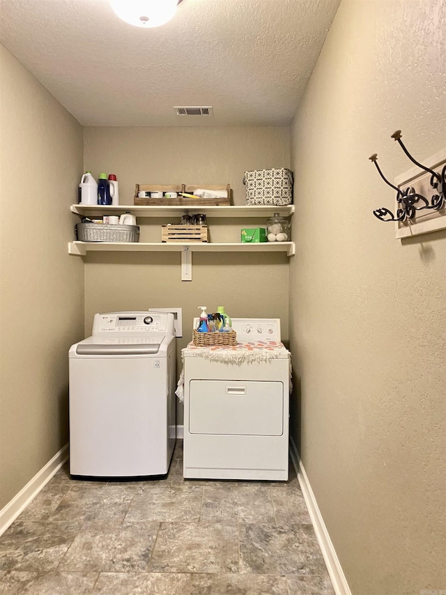 3008 Lilly Ln, Benton, AR 72019 - laundry room with washer and dryer, a textured ceiling, and baseboards