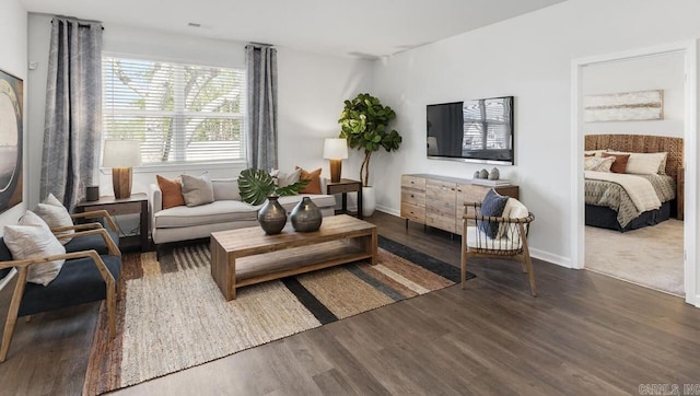 living area with wood finished floors and baseboards