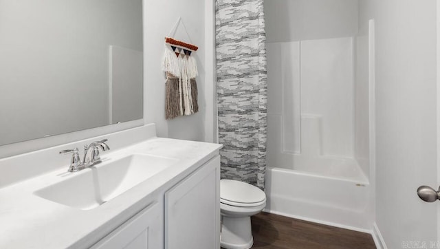 bathroom with wood finished floors, vanity, toilet, and shower / bathtub combination with curtain