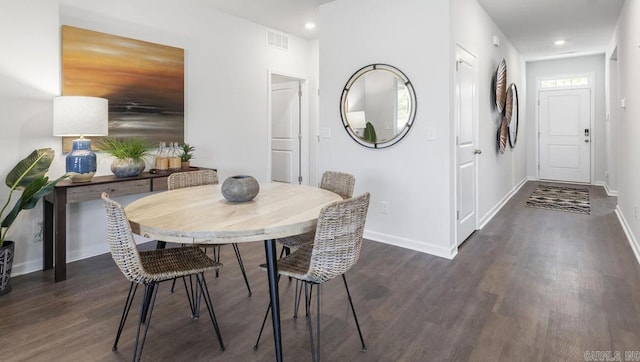 dining room featuring wood finished floors, baseboards, and recessed lighting