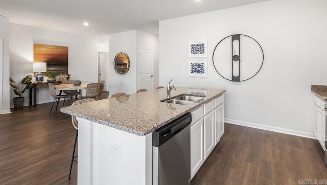 kitchen featuring a sink, dishwasher, dark wood-style flooring, light stone countertops, and recessed lighting