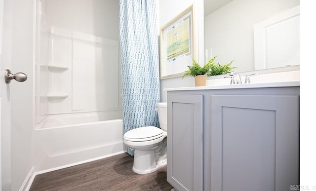 full bathroom with wood finished floors, shower / bathtub combination with curtain, toilet, and vanity