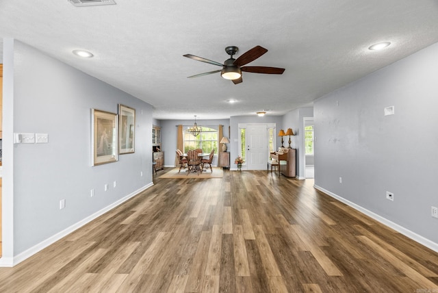 40 Pine Mountain Dr, Conway, AR 72034 - unfurnished living room featuring wood finished floors, a chandelier, ceiling fan, baseboards, and plenty of natural light