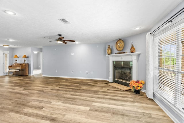 40 Pine Mountain Dr, Conway, AR 72034 - unfurnished living room featuring a ceiling fan, a tile fireplace, baseboards, light wood finished floors, and recessed lighting