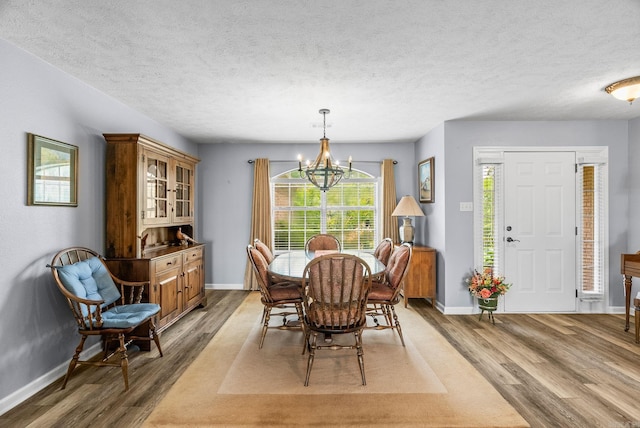 40 Pine Mountain Dr, Conway, AR 72034 - dining room featuring wood finished floors, a chandelier, baseboards, and a textured ceiling