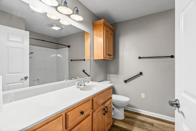 40 Pine Mountain Dr, Conway, AR 72034 - full bathroom featuring toilet, a shower, vanity, wood finished floors, and baseboards