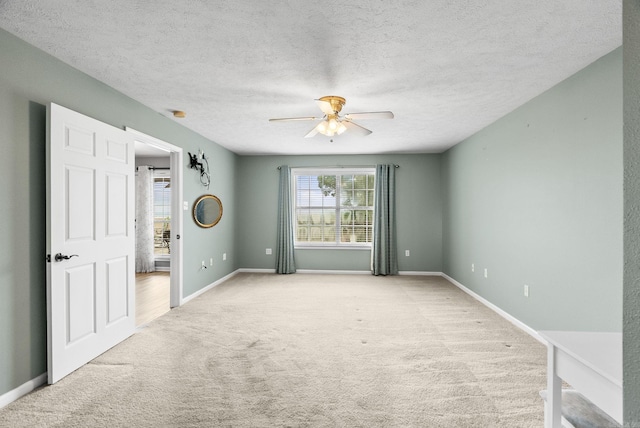 40 Pine Mountain Dr, Conway, AR 72034 - spare room with light carpet, a ceiling fan, a textured ceiling, and baseboards