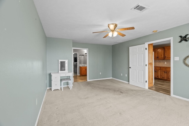 40 Pine Mountain Dr, Conway, AR 72034 - unfurnished bedroom featuring connected bathroom, baseboards, light colored carpet, and ceiling fan