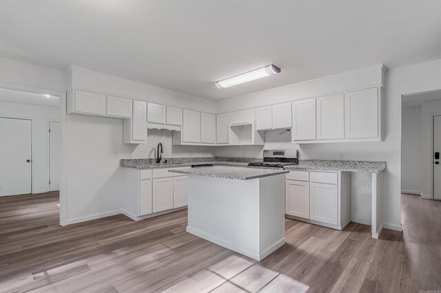 612 Briar St, Sherwood, AR 72120 - kitchen featuring stainless steel range oven, white cabinets, and light wood finished floors