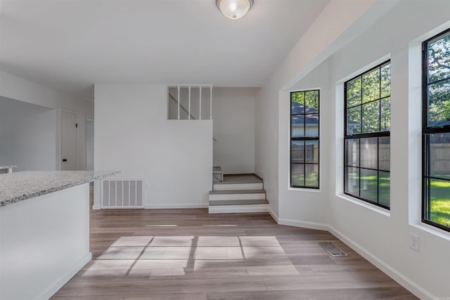 612 Briar St, Sherwood, AR 72120 - unfurnished room with stairway, healthy amount of natural light, wood finished floors, and baseboards