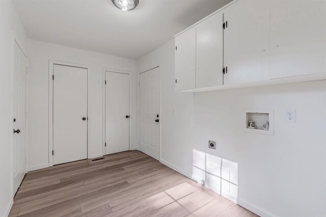 612 Briar St, Sherwood, AR 72120 - laundry room featuring cabinet space, electric dryer hookup, washer hookup, light wood-style floors, and baseboards