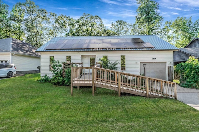 612 Briar St, Sherwood, AR 72120 - view of front of home featuring a garage, roof mounted solar panels, a front lawn, concrete driveway, and metal roof