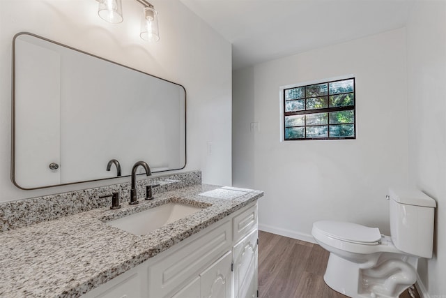 612 Briar St, Sherwood, AR 72120 - bathroom featuring toilet, vanity, wood finished floors, and baseboards