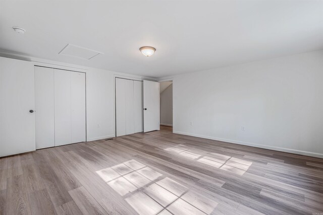 612 Briar St, Sherwood, AR 72120 - unfurnished bedroom featuring multiple closets, wood finished floors, baseboards, and attic access