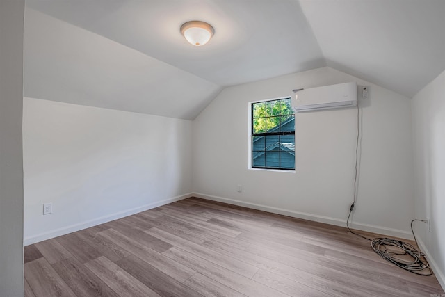612 Briar St, Sherwood, AR 72120 - bonus room with a wall mounted air conditioner, wood finished floors, vaulted ceiling, and baseboards