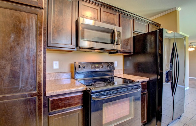 9808 Lanehart Rd, Little Rock, AR 72204 - kitchen with black appliances, ornamental molding, light tile patterned flooring, light countertops, and baseboards
