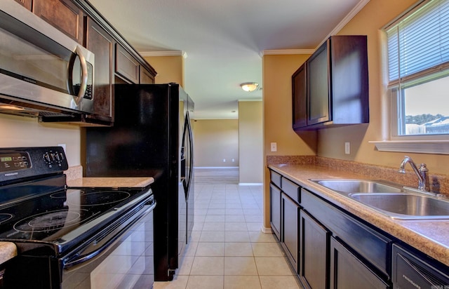 9808 Lanehart Rd, Little Rock, AR 72204 - kitchen featuring black range with electric cooktop, stainless steel microwave, a sink, crown molding, and light countertops