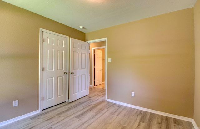 9808 Lanehart Rd, Little Rock, AR 72204 - unfurnished bedroom featuring light wood-style floors, baseboards, and a closet