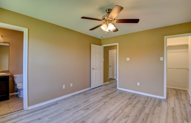 9808 Lanehart Rd, Little Rock, AR 72204 - unfurnished bedroom featuring a spacious closet, light wood-type flooring, and baseboards