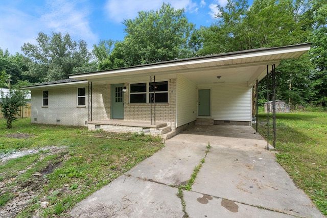 118 Blair St, Searcy, AR 72143 - view of front of property featuring crawl space, concrete driveway, a carport, a front lawn, and brick siding