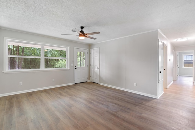 118 Blair St, Searcy, AR 72143 - unfurnished room with a ceiling fan, a textured ceiling, wood finished floors, plenty of natural light, and baseboards