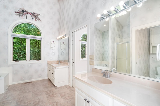 29 Barcelona Way, Hot Springs Village, AR 71909 - full bathroom featuring wallpapered walls, plenty of natural light, two vanities, a garden tub, and a shower stall