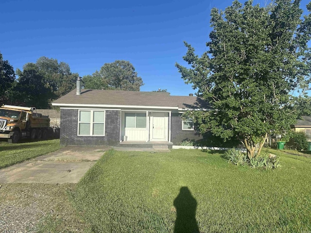 8312 Walkers Dr, North Little Rock, AR 72117 - view of front facade with a front yard, brick siding, and a shingled roof