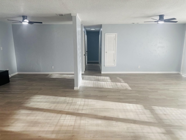8312 Walkers Dr, North Little Rock, AR 72117 - empty room featuring ceiling fan, wood finished floors, a textured ceiling, and baseboards